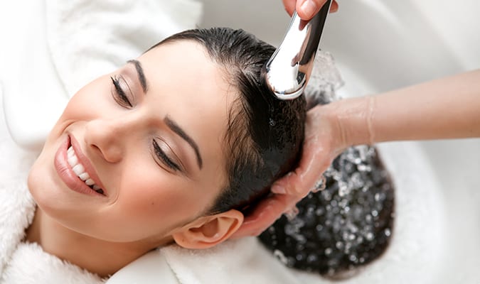Close-up image of a woman getting her hair washed at the Graton Resort & Casino Spa & Salon