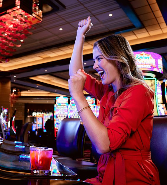Profile view of a woman winning a jackpot in the Non-Smoking Gaming Room